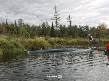 Eva and Garen waiting for assistance after flipping their canoe.