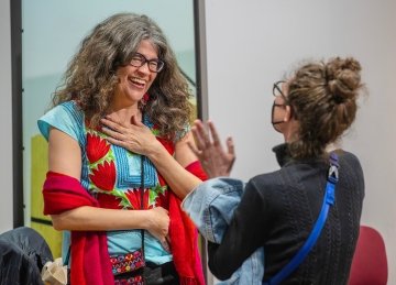 Stephanie Elizondo Griest talking to a student after the panel discussion