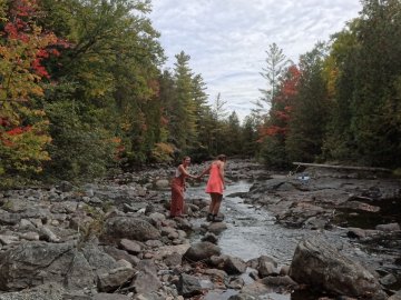 Arcadians Leah and Maddy holding hands and crossing the Hudson River together.