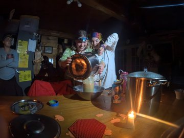 Eva and Jordanna on cleanup crew, putting away pasta sauce together.