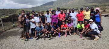Picture of Michael Wairungu (kneeling right) and Njau Kibochi (far left) while conducting research in Kenya in 2022