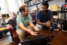 Faculty member and student talking in office