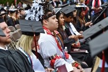 Commencement including Native American in traditional clothing