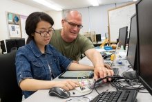 Faculty member working with student on computer