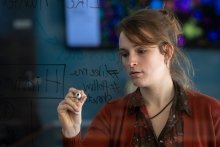 Student writing on a window