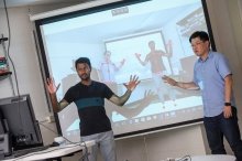 Student and faculty member demonstrating to a class