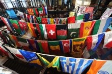 A photo of dozens of different countries' flags hanging up in the student center.