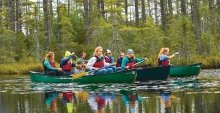 A photo of St Lawrence students canoeing on a lake. 